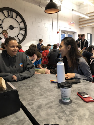 Juniors Kiara Baxter and Abbey Trinidad wait to be released into the gym for the PSAT. The new freshmen taking the test for the first time gathered behind them.
