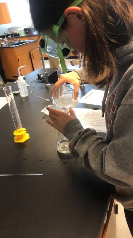 Ava Mager (‘20) does a Chemistry lab in her college sweatshirt on a Thursday during the 2018-19 school year, before hoodies were banned to wear Monday-Thursday.