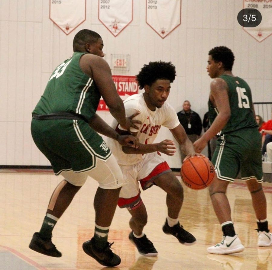 Christian Moore (‘21) dribbles between two Benedictine defenders, Cape Henry defeated Benedictine with a final score of 76-64.
Photo credit: Dan Burke